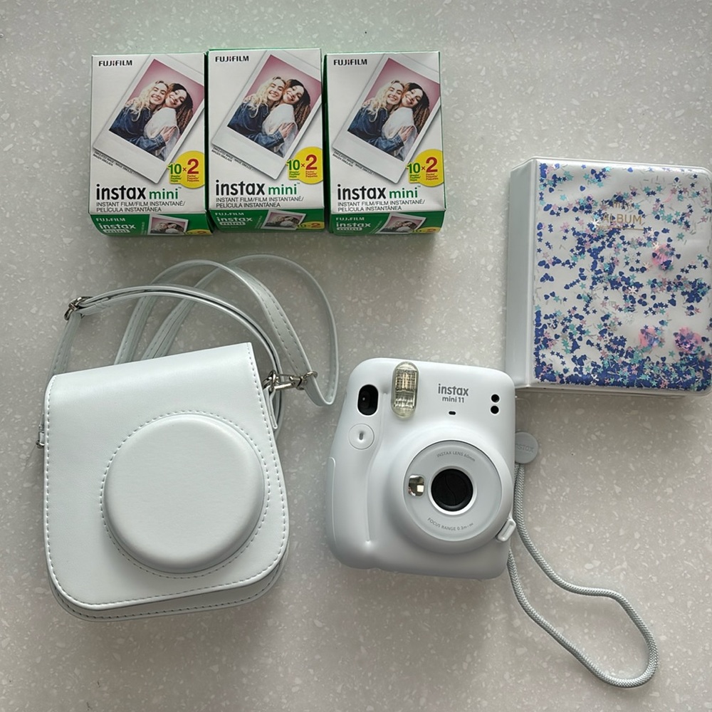 Instax mini 11 camera with carrying case, 60 sheets of film, and a photo album